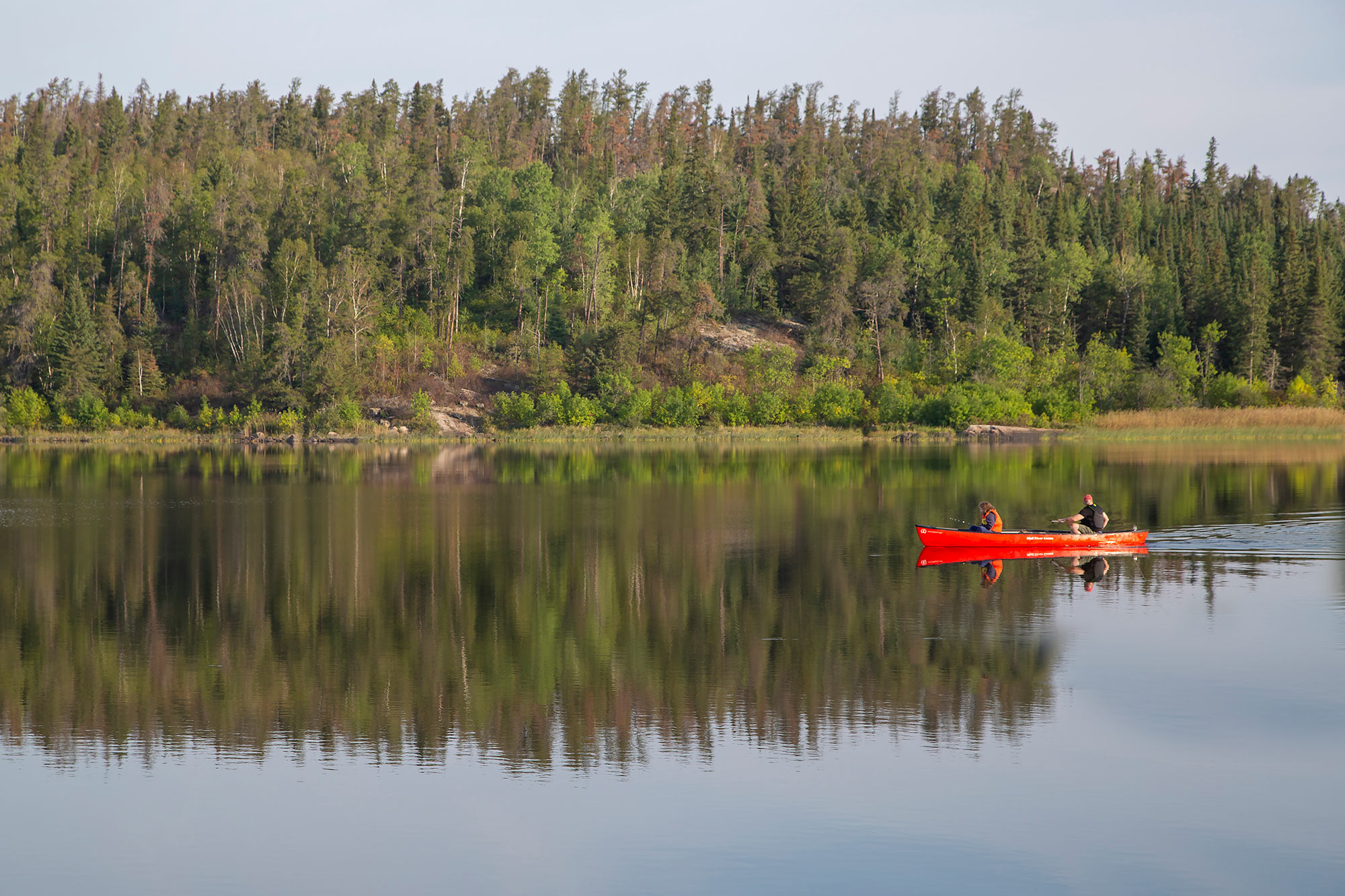 Solutions: red canoe in body of water